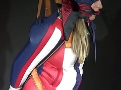 Watching Sexy Sandra Wearing A Sexy Oldschool Downbib And A Down Jacket Being Suspended, Tied, Gagged And Hooded With Ropes And A Ballgag (Video)